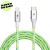 Introducing the ChargeCords Lime USB-C to Lightning Cable [10 ft / 3m length], featuring a neon green and blue braided fabric that glows in the dark! This Apple MFi Certified cable charges your iPhone up to 2x faster. "GLOWS IN THE DARK!" is proudly displayed in the top left corner.