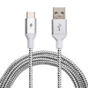 A ChargeCords Black and White USB-C to USB-A Cable lies on a white background. The USB-A connector displays the standard USB symbol, while the USB-C connector boasts a lightning bolt icon. The cable's rugged, tangle-proof fabric features a white base with black speckles for a patterned appearance.