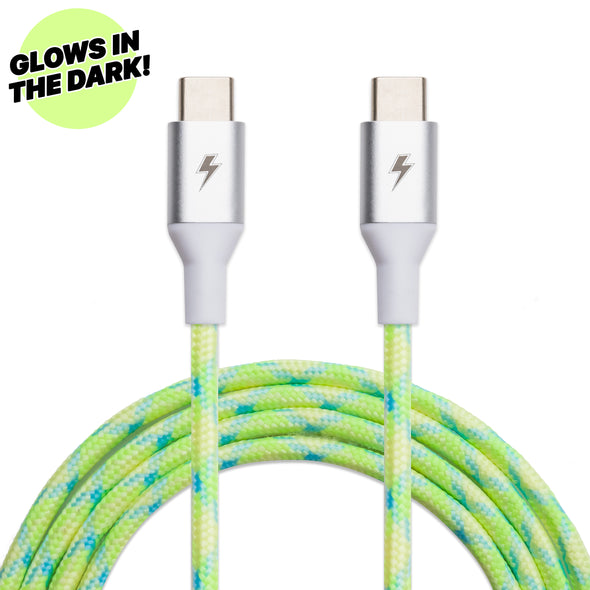 Close-up of the ChargeCords Lime USB-C to USB-C Cable [6 ft / 1.8m length] with a tangle-proof neon green braided exterior that glows in the dark. The cable ends feature a silver-colored casing with a lightning bolt icon. Compatible with USB 3.1 devices, it includes a circular label in the top left corner that reads "GLOWS IN THE DARK!