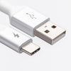 Close-up of two types of USB cables against a white background. The left cable is the ChargeCords Black and White USB-C to USB-A Cable featuring a lightning bolt symbol and reinforced aluminum shielding, while the right cable is a standard USB Type-A with the USB symbol. Both have silver connectors and white plastic casings.