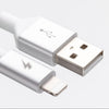 Close-up image of a white USB Type-A connector and an Apple MFi Certified Lightning connector from the ChargeCords Black and White Glow Lightning Cable [5 ft / 1.5m length]. The USB connector features the standard USB symbol, while the Lightning connector, designed for iPhone compatibility, has a lightning bolt symbol. Both connectors are reinforced with aluminum shielding for durability.