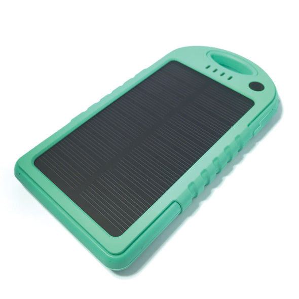 The Minty Fresh Solar Bank by ChargeCords is a turquoise portable solar charger with a black solar panel surface. The device features quick charging capability and boasts a rugged design with vertical ridges on the sides, a small LED indicator light, and an oval handle at the top. It is placed on a white background.